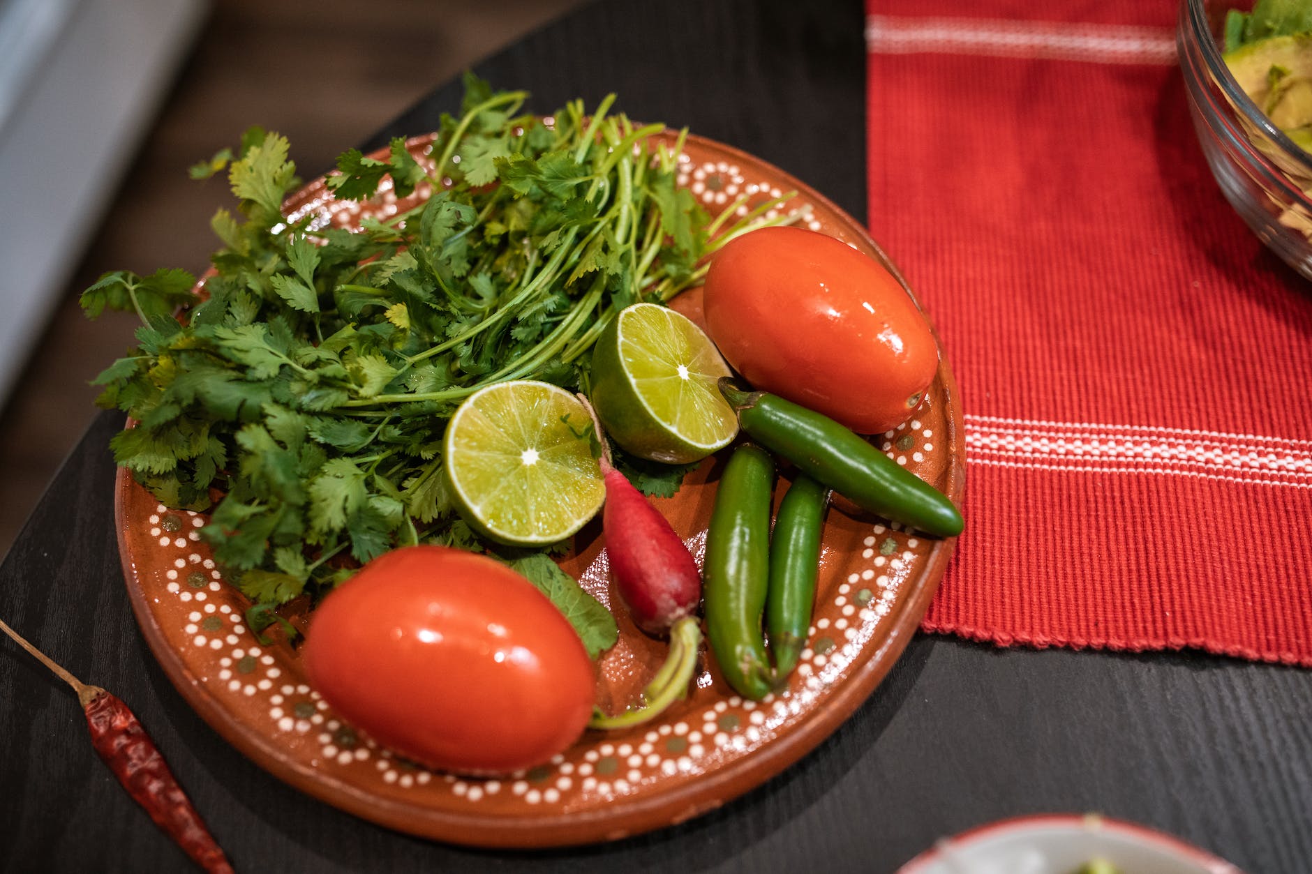 a fresh vegetables and fruits on a ceramic plate