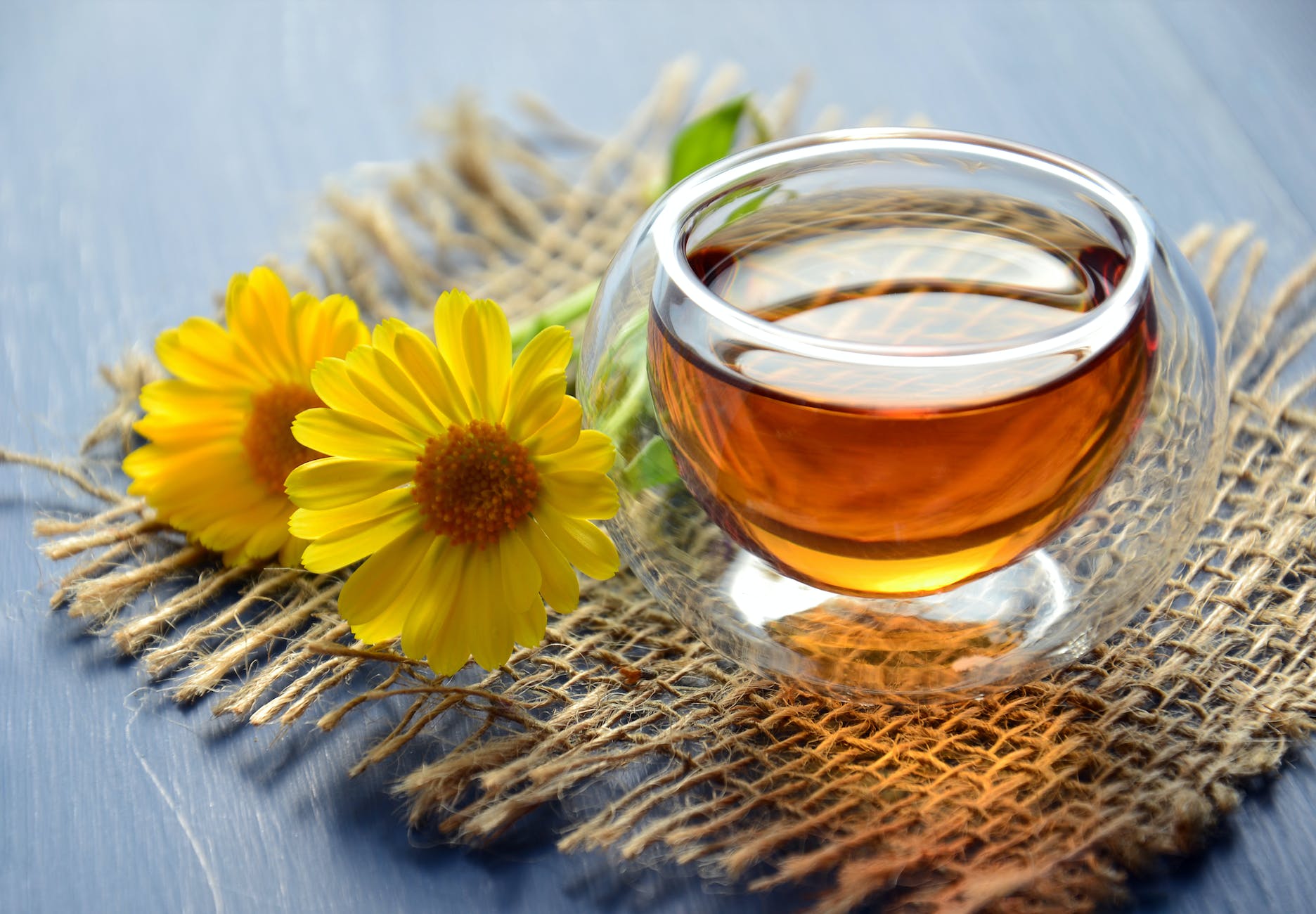 clear glass bowl beside yellow flower