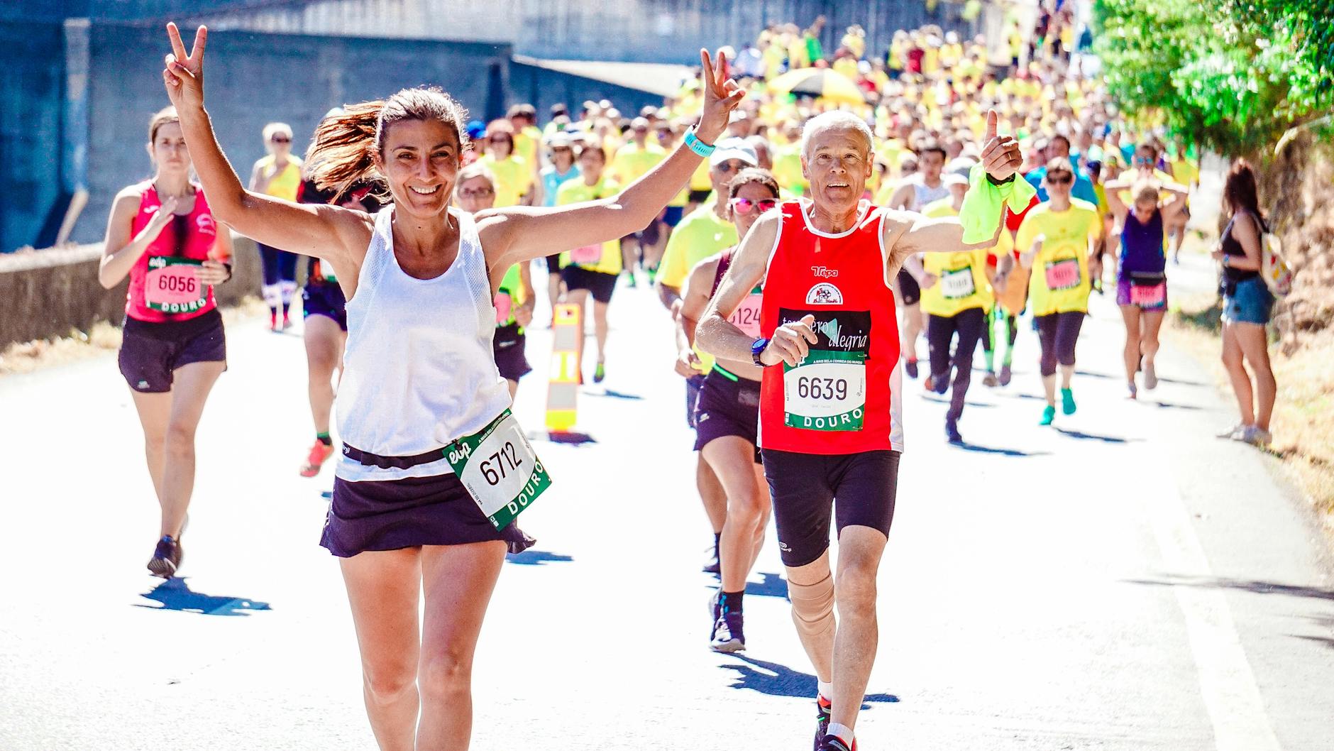 female and male runners on a marathon