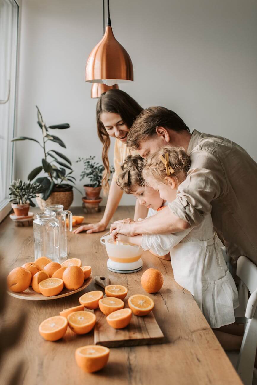 a man teaching the kids to make juice