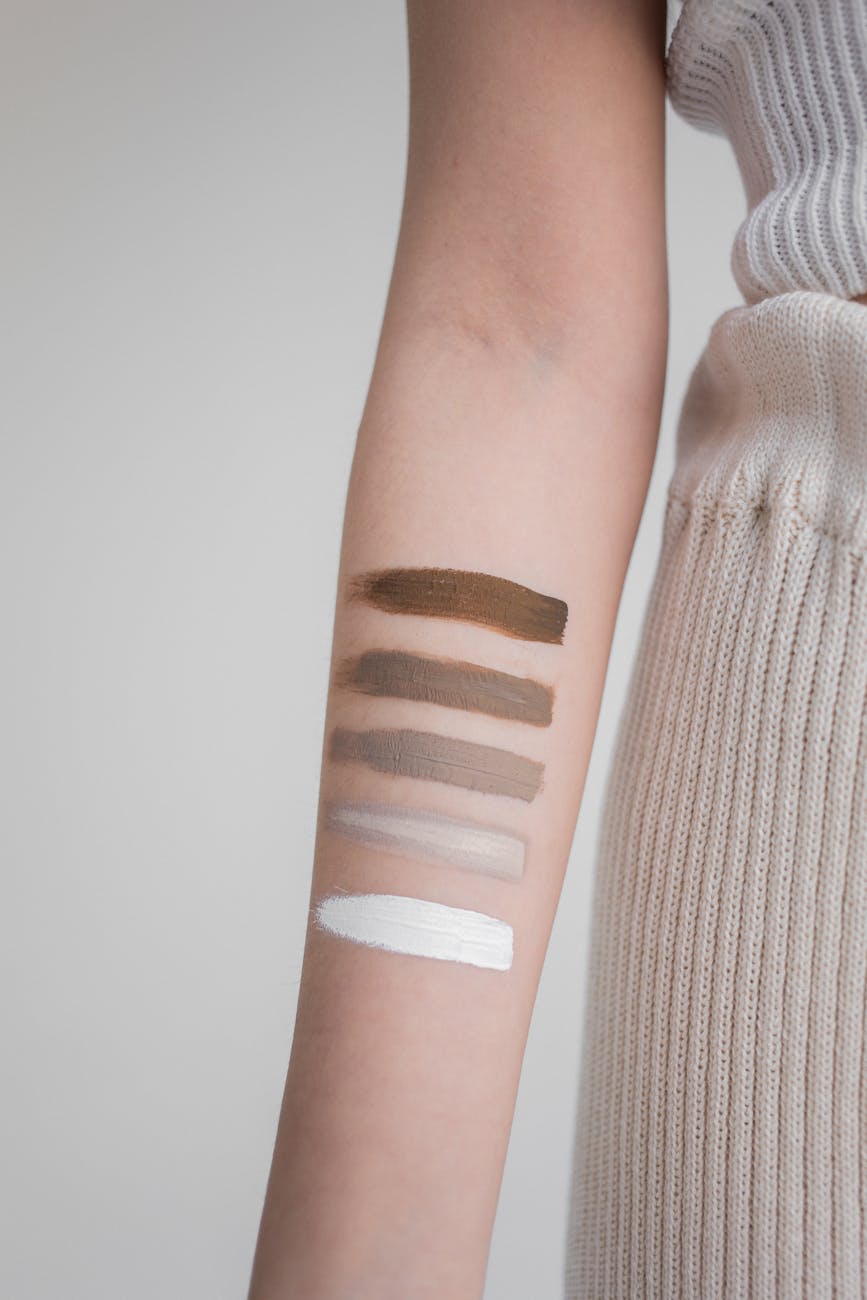 crop woman with swatches on skin