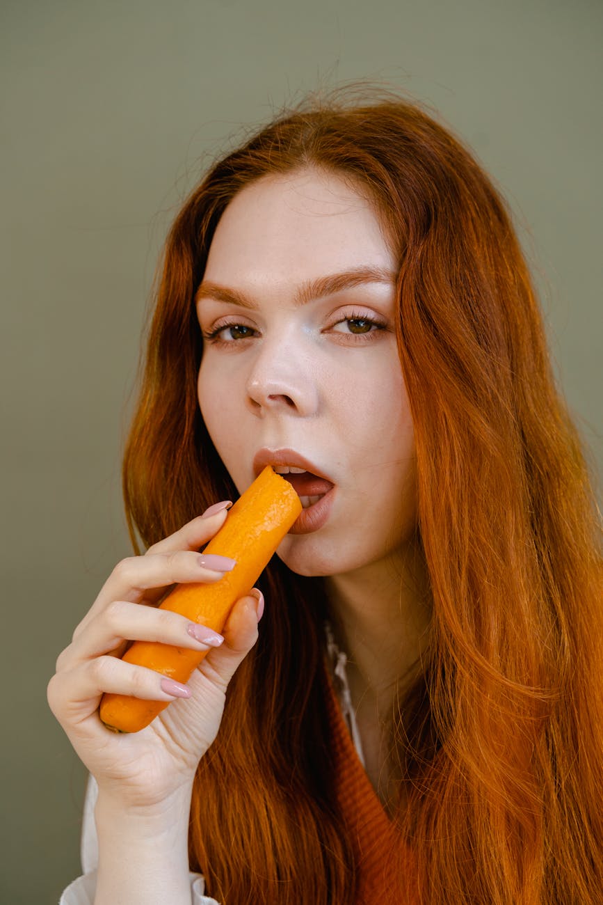 a woman holding a carrot