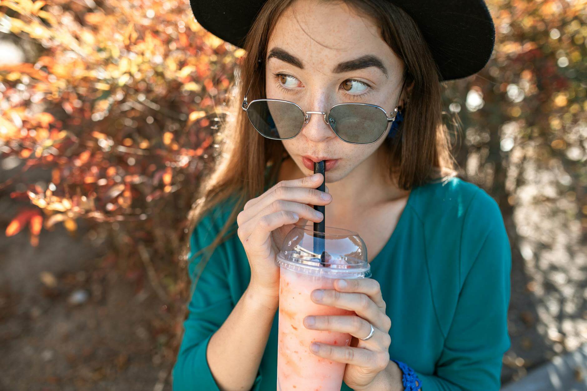 woman with sunglasses drinking milkshake